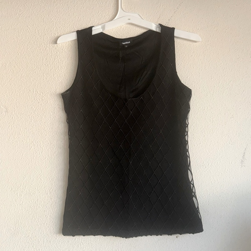 Black sleeveless top with embroidered diamond pattern